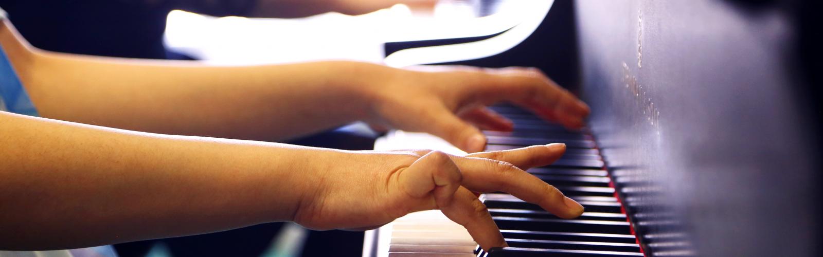 Young student's hands at piano